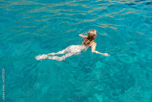 Im Urlaub nackt im kühlen türkisen Meer schwimmen.