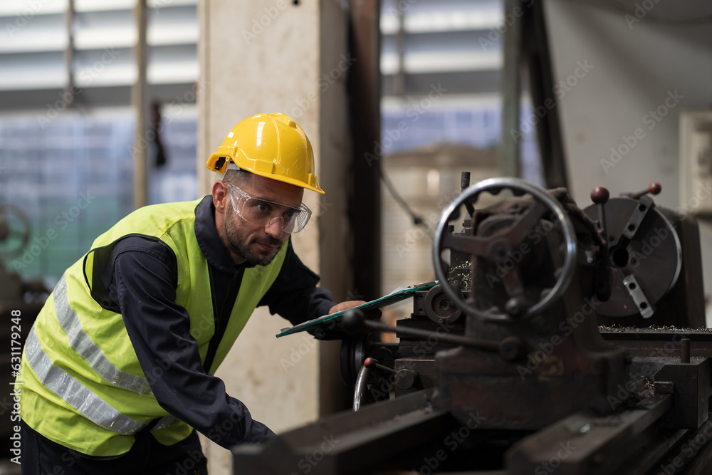 Male engineer worker maintenance lathe machine in industry factory. Male technician worker working and operation machine in plant. Male worker inspecting quality parts of machine Male engineer worker maintenance lathe machine in industry factory. Male technician worker working and operation machine in plant. Male worker inspecting quality parts of machine