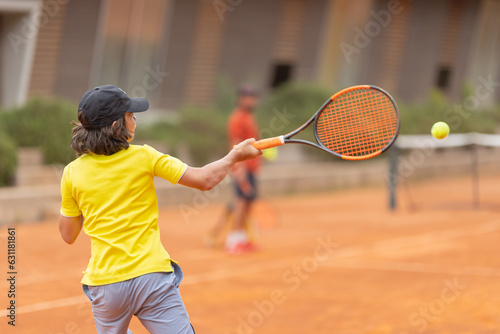 A little boy hitting back the tennis ball © KONSTANTIN SHISHKIN