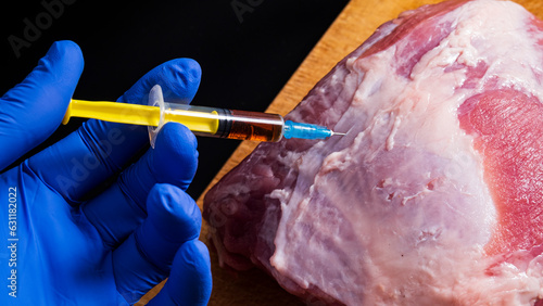 Canvastavla Injection from a syringe into raw meat on a dark background