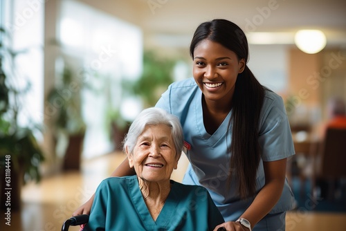 Senior woman and her female caretaker in a nursing home smiling photo