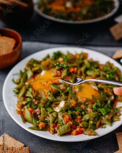 a front view sliced vegetable meal fried colorful vegetables meal along wtih bread loafs eggs inside white plate on the grey background