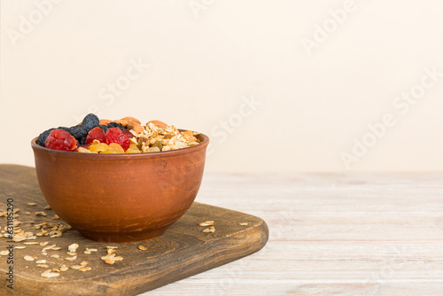 Cooking a wholesome breakfast. Granola with Various dried fruits and nuts in a bowl. The concept of a healthy dessert. Flat lay, top view with copy space