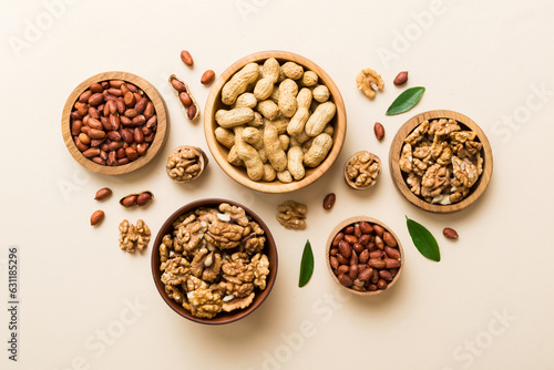 Walnut kernel halves, in a wooden bowl. Close-up, from above on colored background. Healthy eating Walnut concept. Super foods with copy space © sosiukin