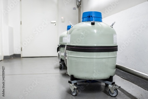 Grey liquid nitrogen tank storage with unmounted withdrawal device cryogenic hose. Metal tank or dewar