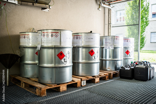 Big metal containers containing chemical waste from laboratories, waste management concept, color barrels