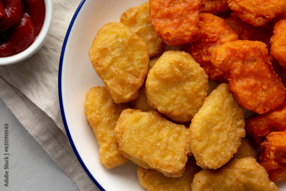 Homemade Spicy Chicken Nuggets Mix on a Plate, top view. Close-up. Homemade Spicy Chicken Nuggets Mix on a Plate, top view. Close-up.