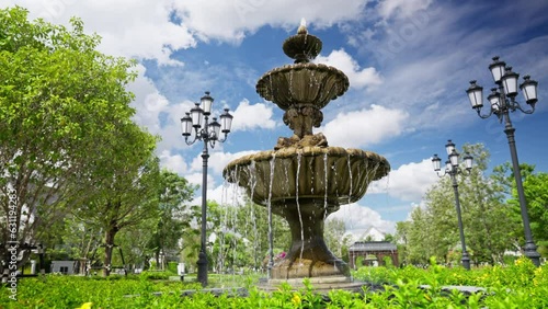 In a luxurious garden, a mesmerizing fountain takes center stage. Water cascades gracefully, reflecting the surrounding beauty and creating a tranquil oasis of elegance . High quality 4k footage