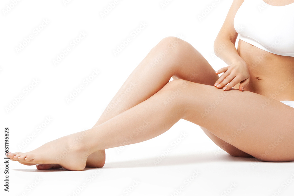 Slim young woman sits in underwear on white background