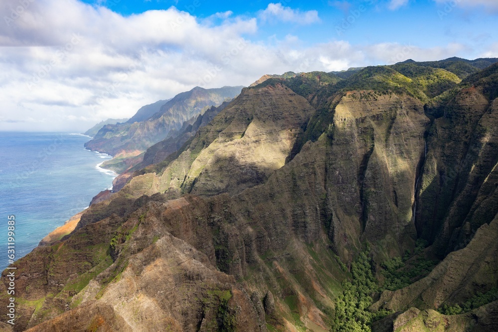 Aerial view of green mountains against the sea in Waimea Canyon State Park in Kauai County, Hawaii