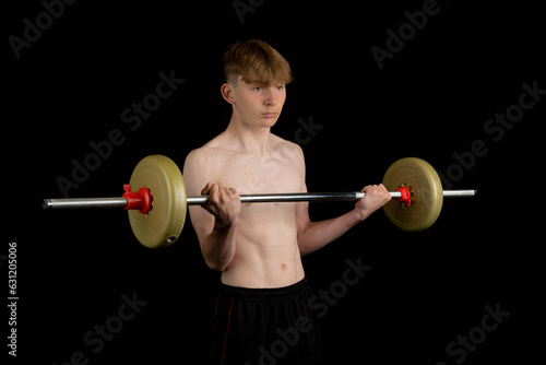 Teenage boy using a barbell