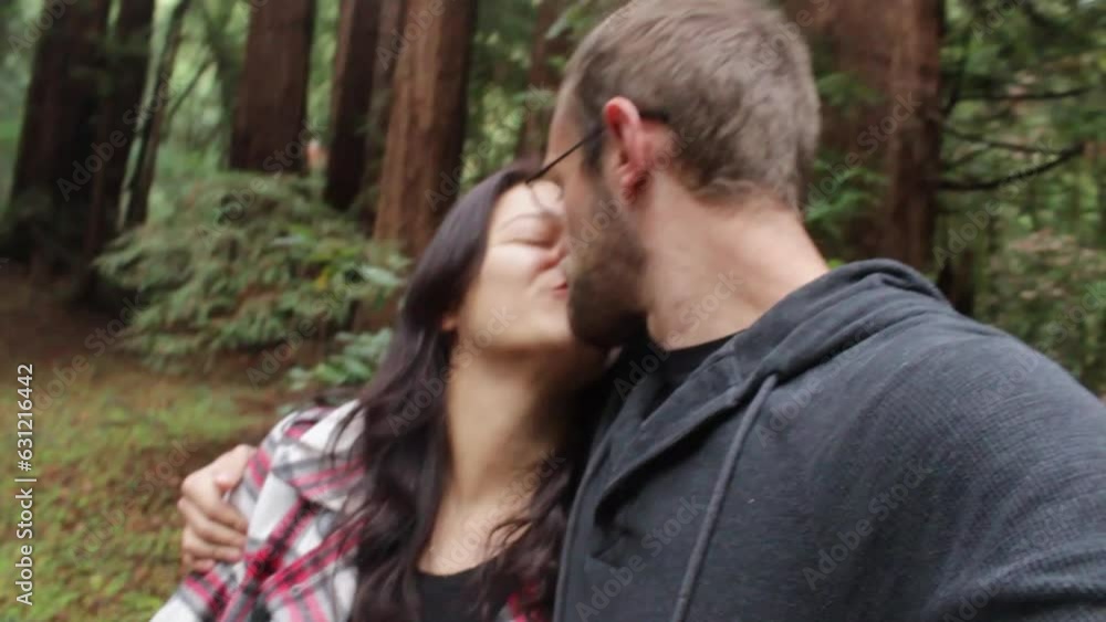 Slow-motion view of a Caucasian lovely couple walking in a forest Slow-motion view of a Caucasian lovely couple walking in a forest