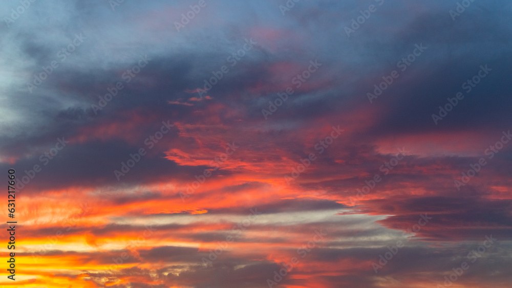 Sunset sky with vibrant red clouds, vibrant evening clouds, ideal for sky replacement in photography