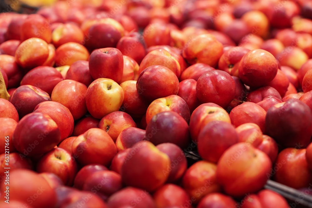 A large bunch of sweet peach. The fruit is an organically grown produce. Sold in Supermarket A large bunch of sweet peach. The fruit is an organically grown produce. Sold in Supermarket