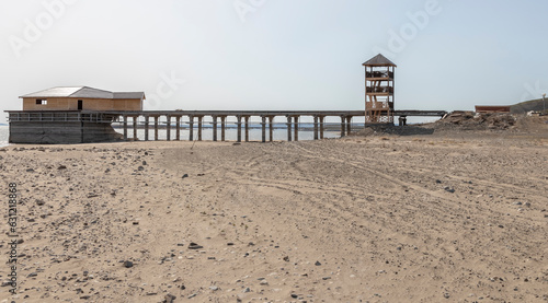 pier on the beach with a wooden watchtower