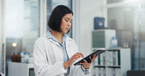 Tablet, typing and woman or doctor, hospital or clinic office for healthcare software, telehealth or research. Search, online charts or report of medical professional or asian person on digital tech