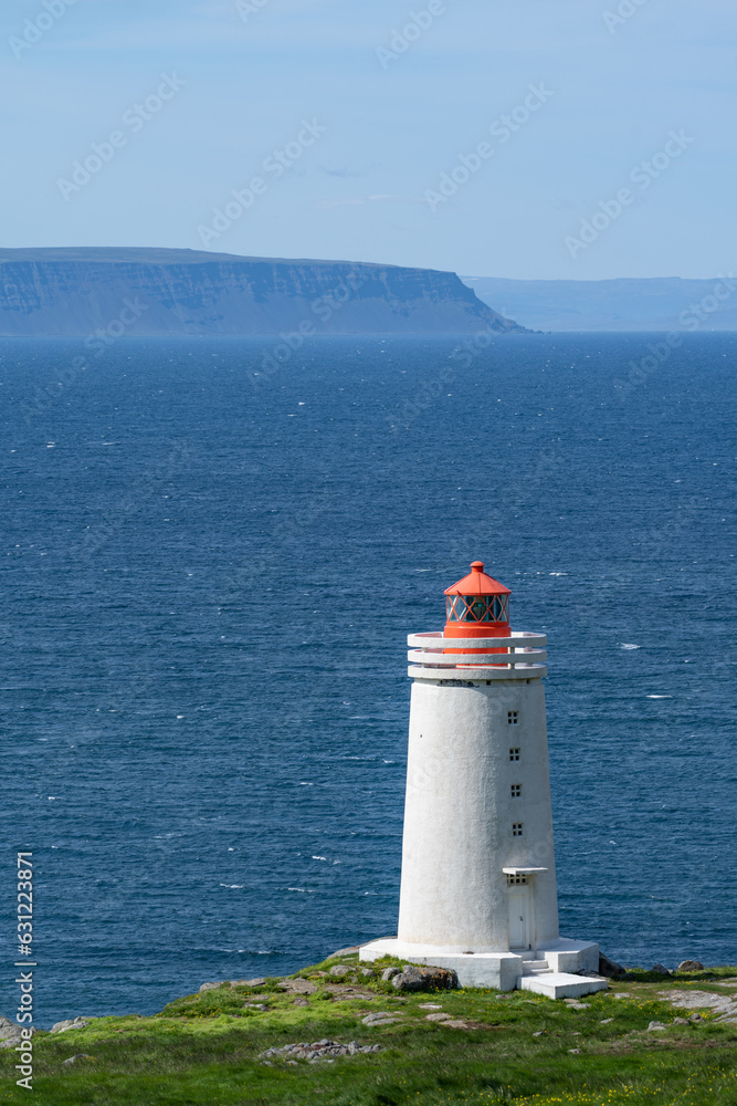 Skardsviti Lighthouse along the edge of a cliff on a sunny day near Hvammstangi, Iceland