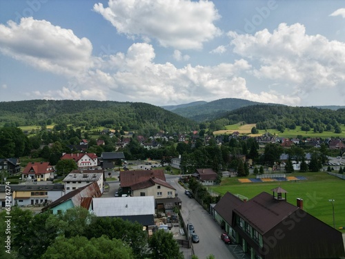 Scenic aerial view of a small rural town featuring an array of clustered buildings and green fields