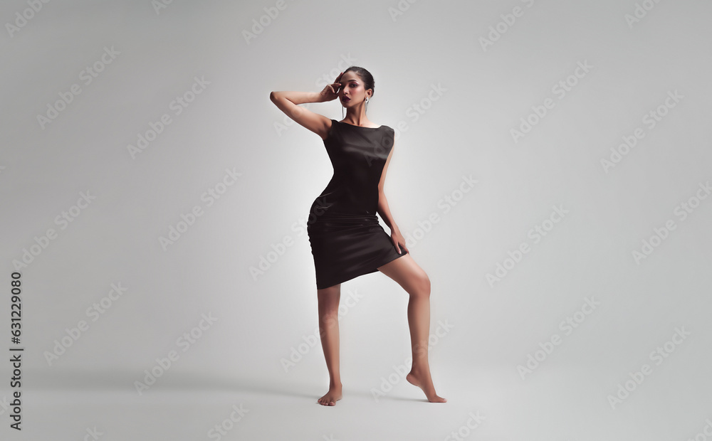 Model posing ethereal dance in isolated grey background