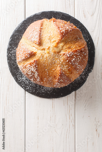 Mona or mouna of Easter is a traditional mediterranean sweet bread baked to celebrate Easter closeup on the wooden table. Vertical top view from above photo