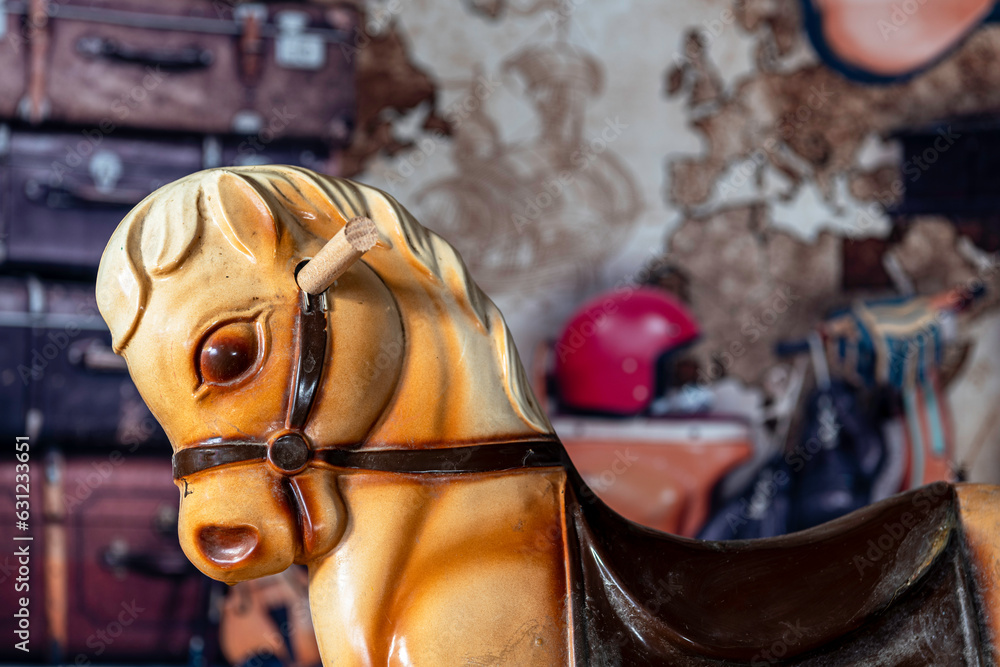 child’s antique hobby horse with old attic background Stock Photo