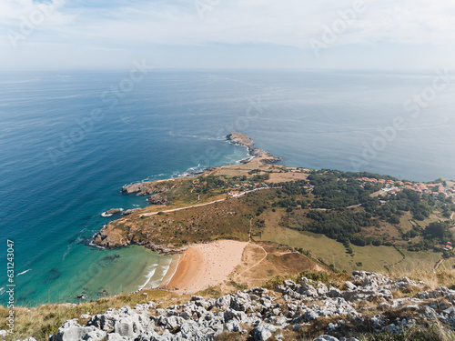 Wide landscape from the Candina peak in Cantabria towards the Sonabia beach and the Cantabrian sea near Oriñon. A sunny summer day. photo