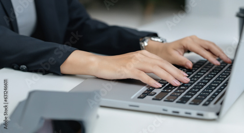woman in a suit in front of a computer writing