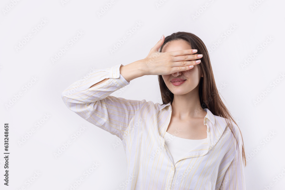 Portrait of a serious young woman showing stop gesture with her palm over white background Portrait of a serious young woman showing stop gesture with her palm over white background