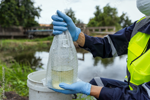 Environmental researchers investigate the condition of canal water for toxic spills, river waste water sampling, Asian researchers collect water samples in farmland for research and development.