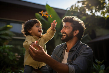 Indian young father and small kid playing, cuddling, flying plane, floating boat