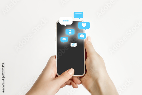 female hand holding and using a social media on mobile phone with notification icons