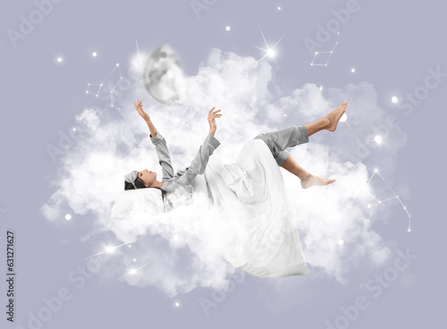 Beautiful young woman with pillow and blanket lying on soft cloud against grey background