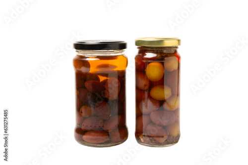 Delicious red olives in a jar isolated on white background. Pickled olives in a glass jar. Delicious olives. Close-up. Vegan.