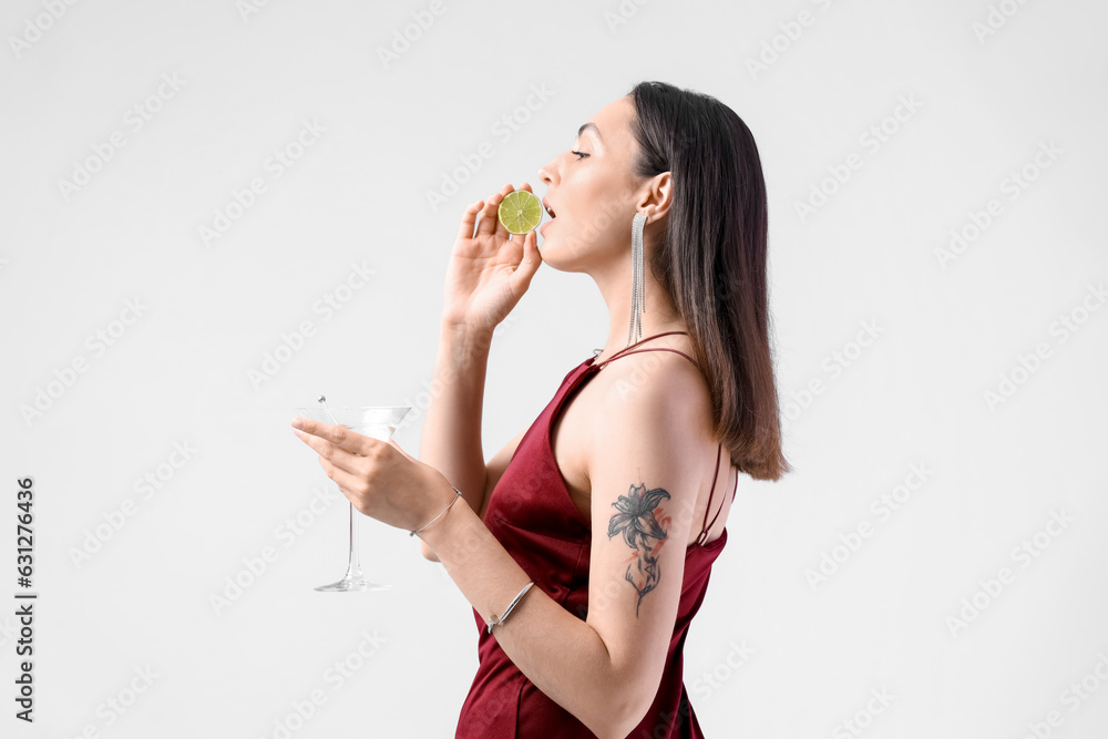 Beautiful woman with martini and lime on light background Beautiful woman with martini and lime on light background