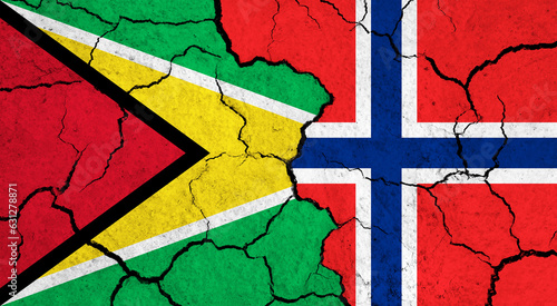 Flags of Guyana and Norway on cracked surface - politics, relationship concept