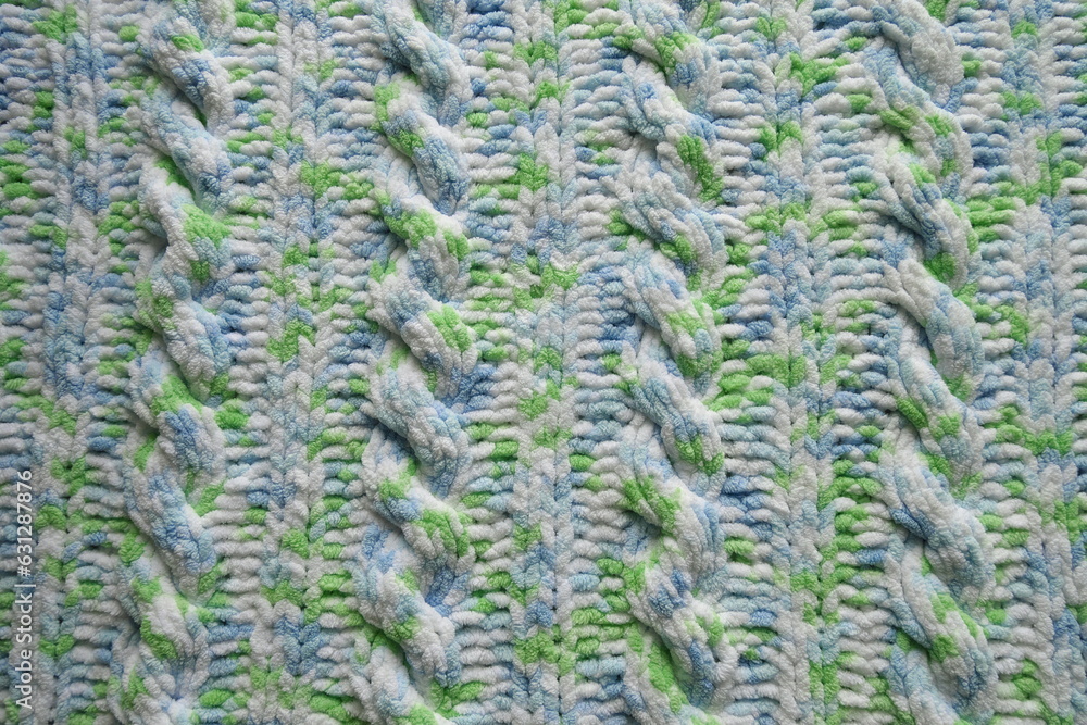 Blue and green Aran braid cable stitch knitting pattern background Blue and green Aran braid cable stitch knitting pattern background