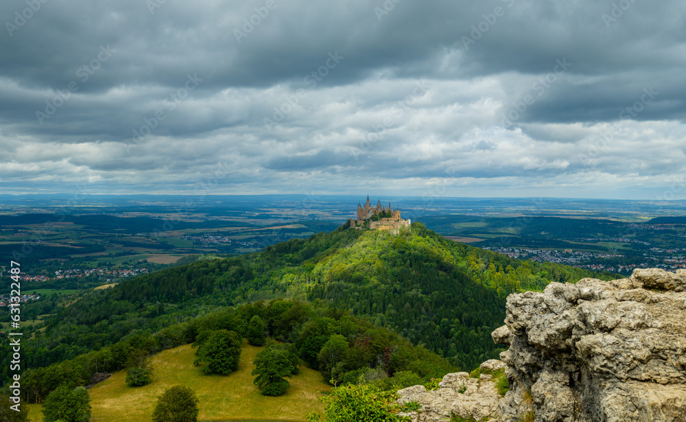 Obraz premium View of the Hohenzollern castle in Germany. The famous fabulous gothic landmark in the vicinity of Stuttgart. Summer travel in Europe, famous travel destination.