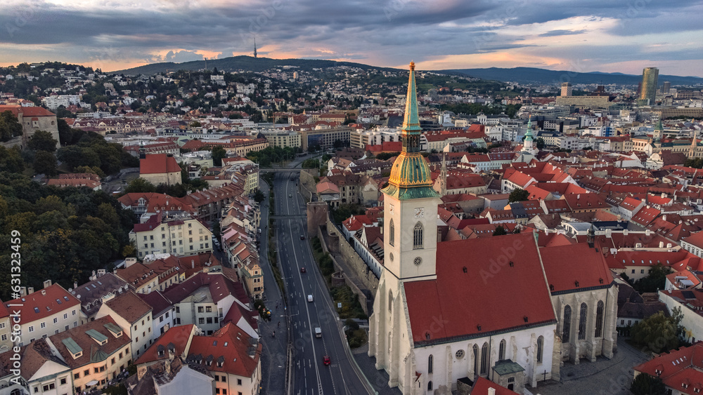 Bird's eye view taken from a drone at night - panoramic view of a city in Europe, Bratislava ( Slovakia ) with traffic and streetlights on the church