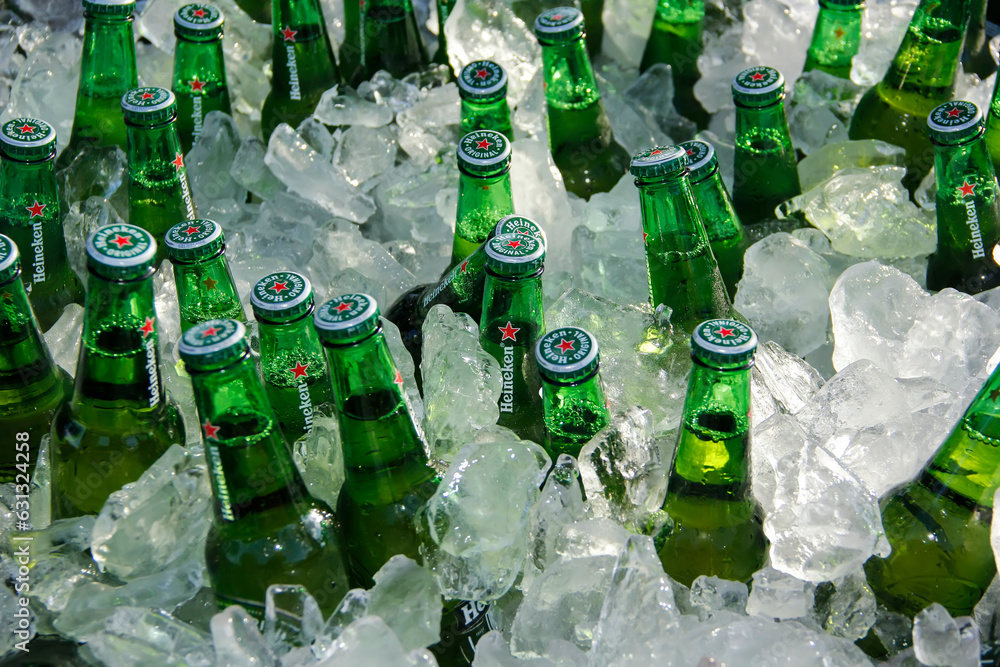 several green bottles of Heineken beer on ice Stock Photo Adobe Stock