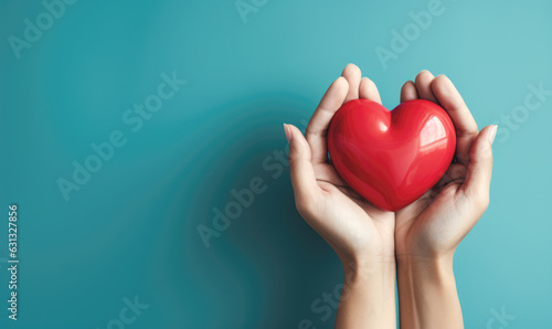 Hand giving red heart , charity symbol