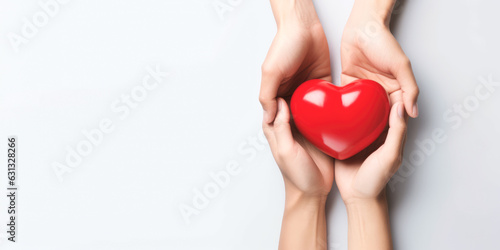 Hand giving red heart , charity symbol