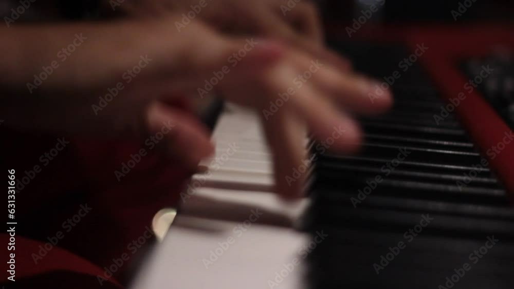 detail of hands playing keyboard