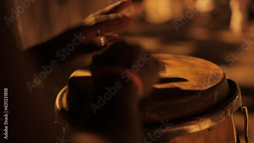 detail of hands playing timbal percussion instrument
