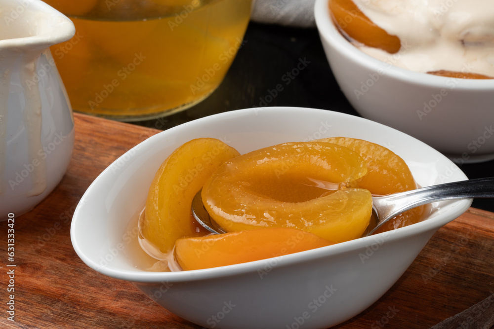 Focus on delicious canned peaches in a bowl. Focus on delicious canned peaches in a bowl.