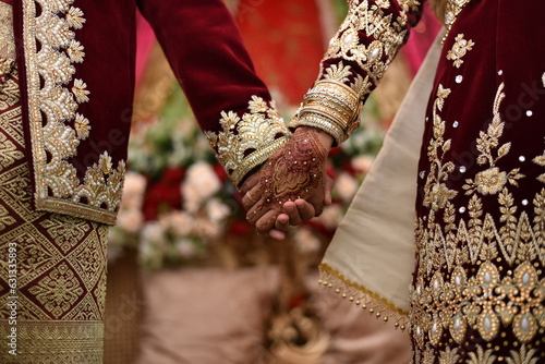 Minangkabau traditional costumes at weddings, couple holding hands, pliers ornament