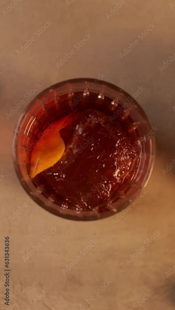 Top of glass of Negroni cocktail on a bar Top of glass of Negroni cocktail on a bar