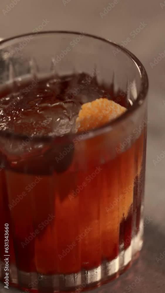 Close-up a glass of Negroni cocktail on a bar Close-up a glass of Negroni cocktail on a bar