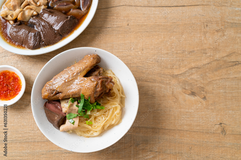 dried noodles with braised duck in white bowl