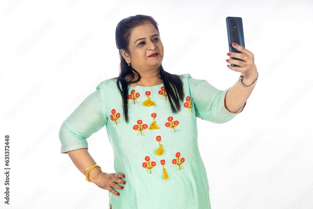 Indian woman using smartphone on white background. Indian woman using smartphone on white background.