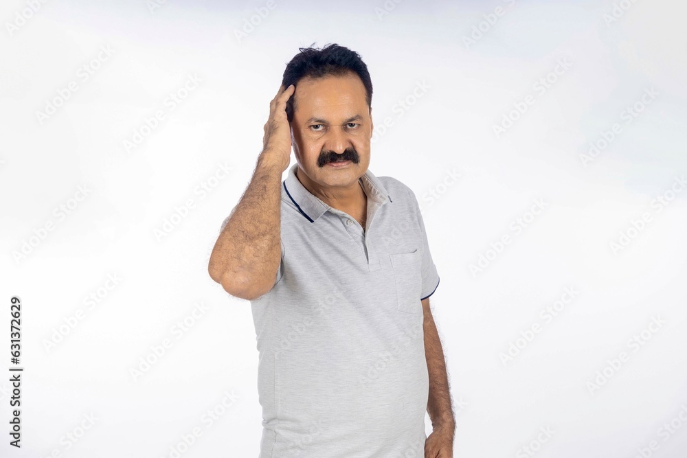 Confident indian man in t shirt standing on white background. Confident indian man in t shirt standing on white background.